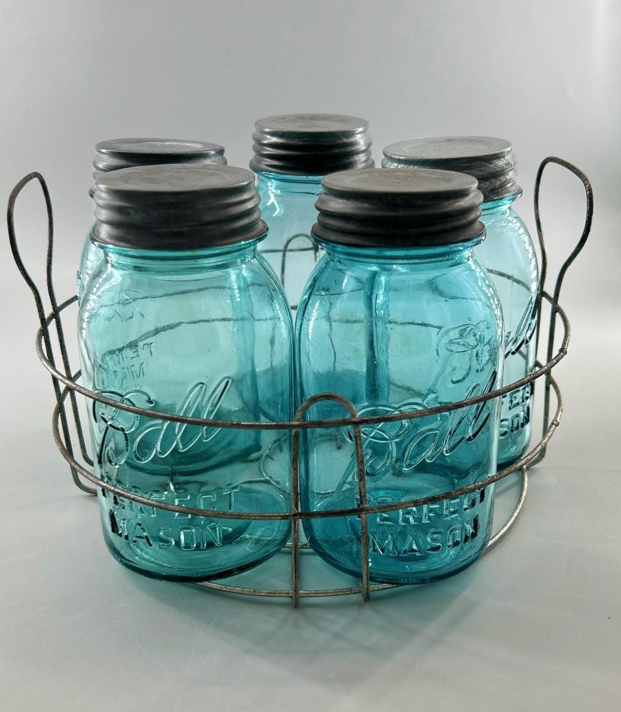 Set of five antique Ball Perfect Mason jars in aqua blue glass with zinc lids, in their original wire carrier