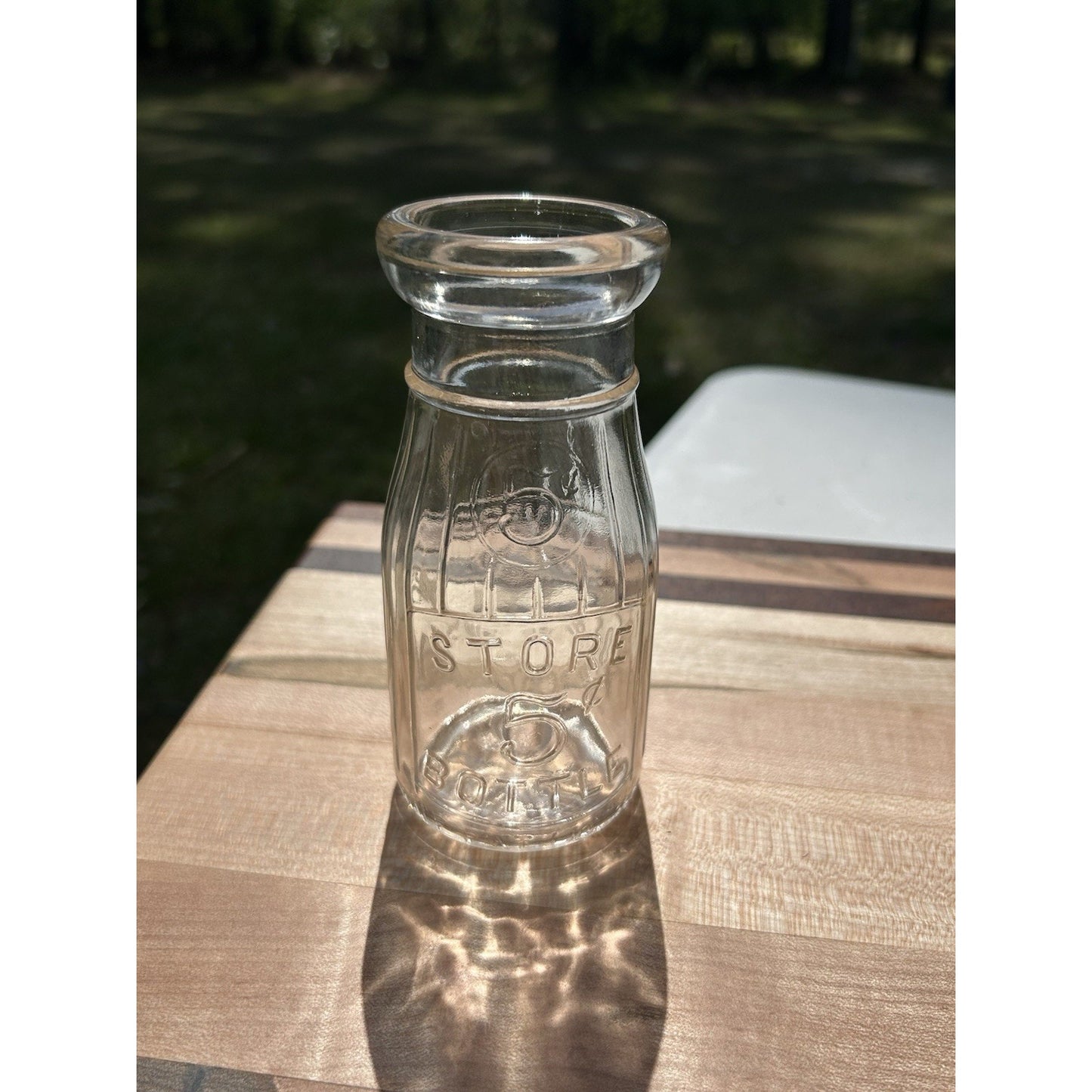 Half pint Universal Store milk bottle side view 5 cent deposit
