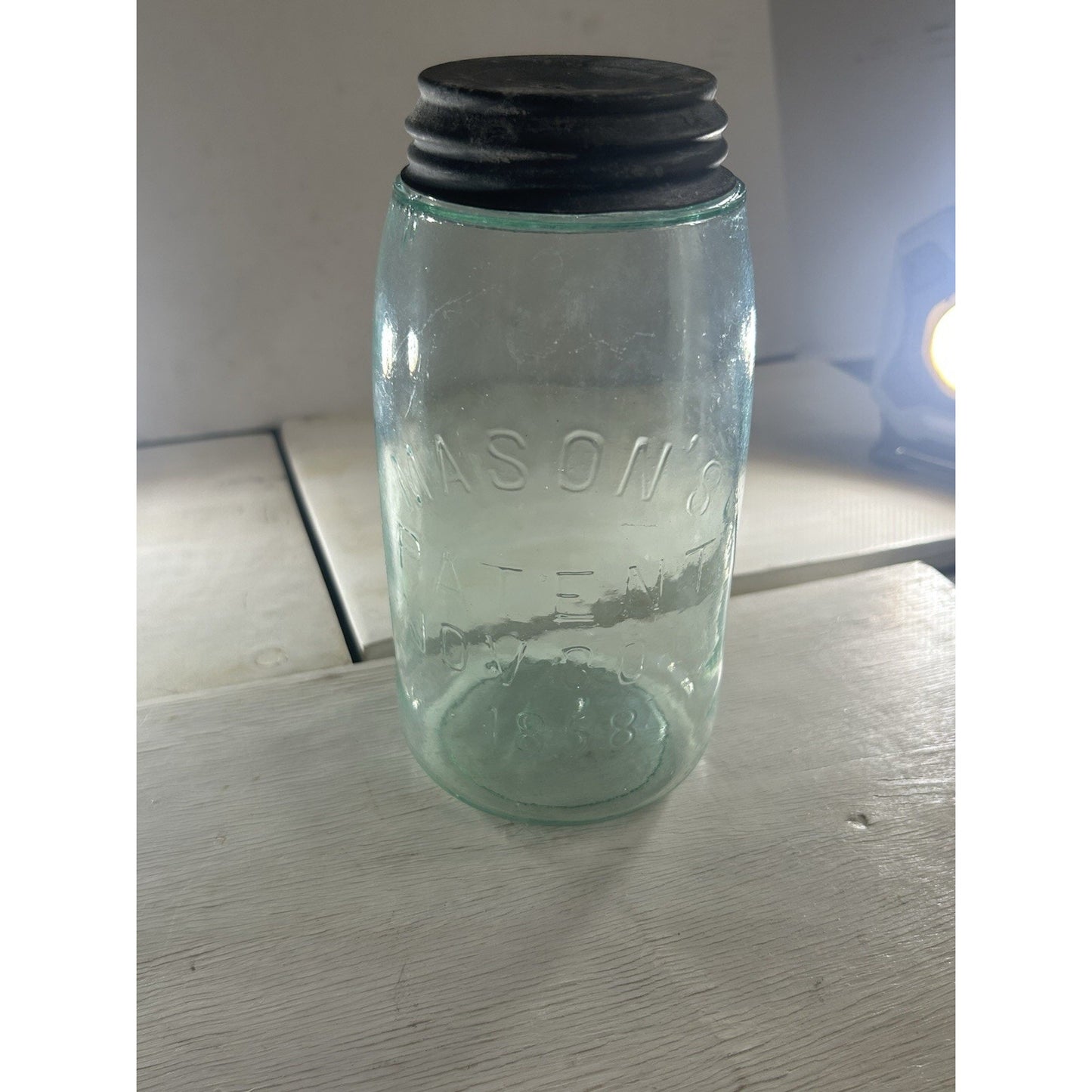 Antique Mason 1858 jar embossed text close-up — patent date and Mason's name on aqua glass body