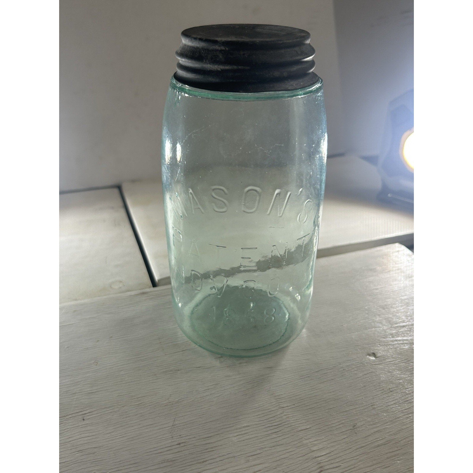 Antique Mason 1858 jar embossed text close-up — patent date and Mason's name on aqua glass body