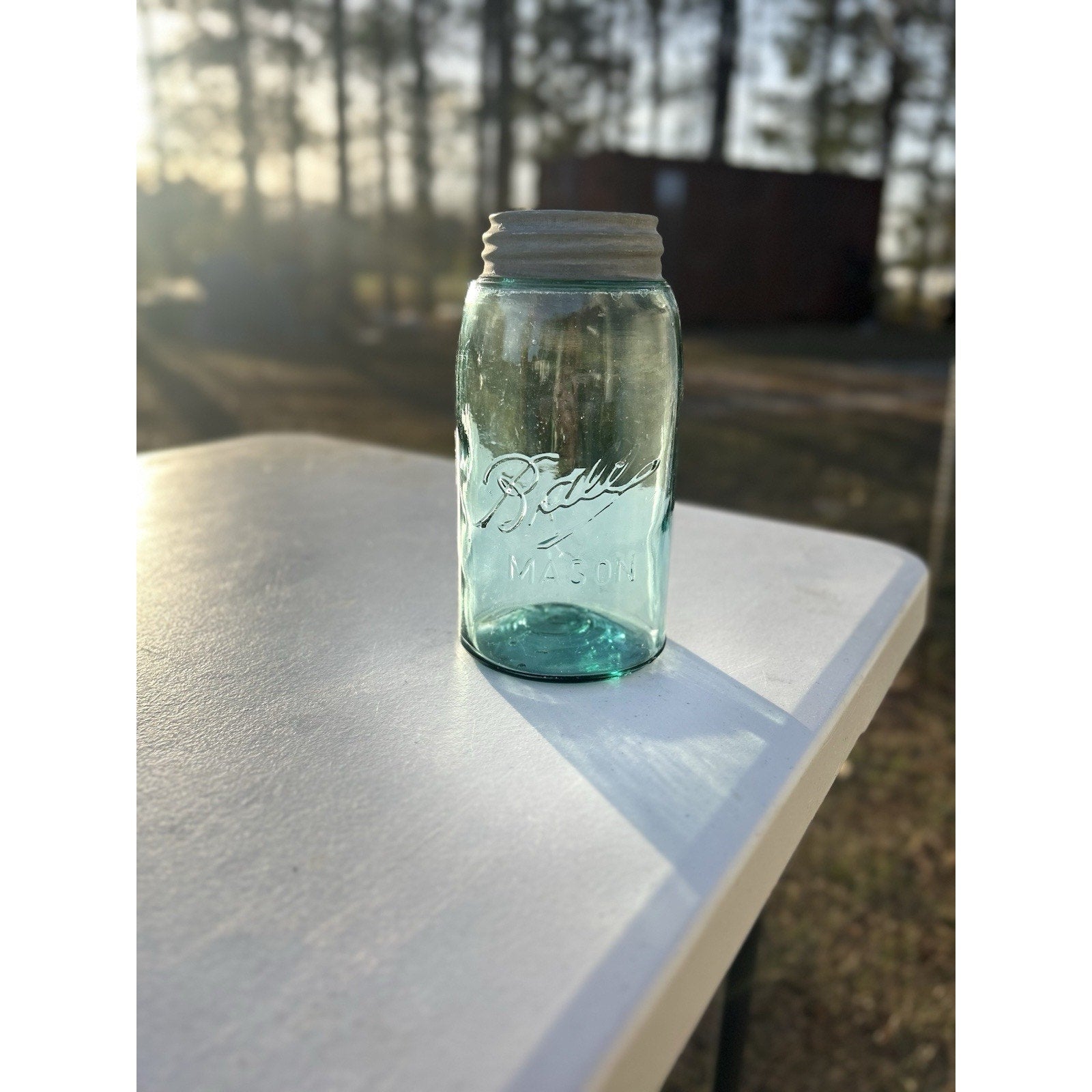 Antique Ball Triple-L mason jar 1900-1910 — natural light scale reference showing quart size and aqua color depth