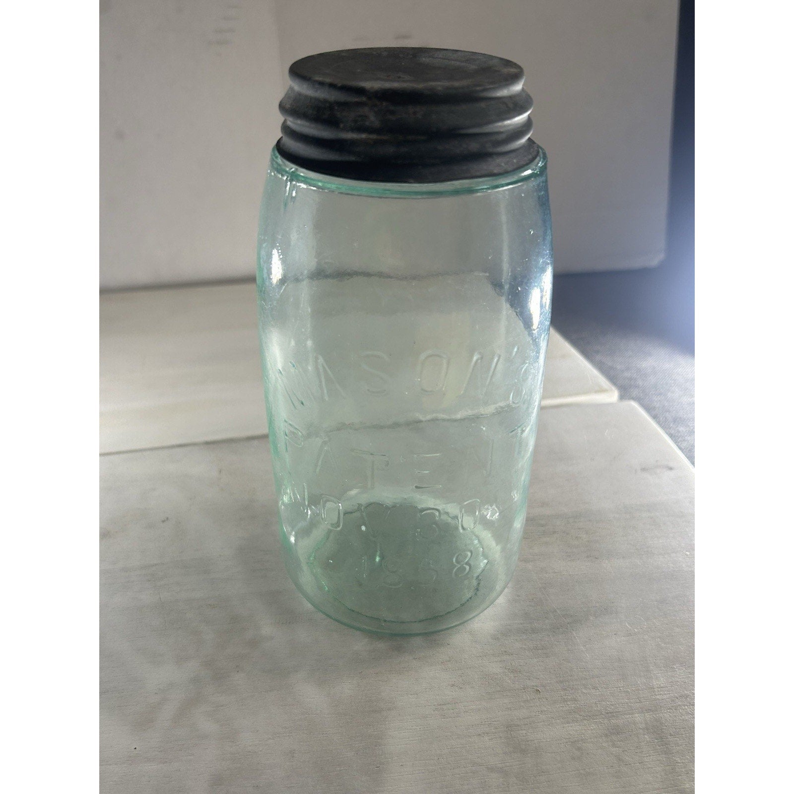 Mason's Patent 1858 quart jar angled view — embossed text, aqua color, and zinc lid all visible