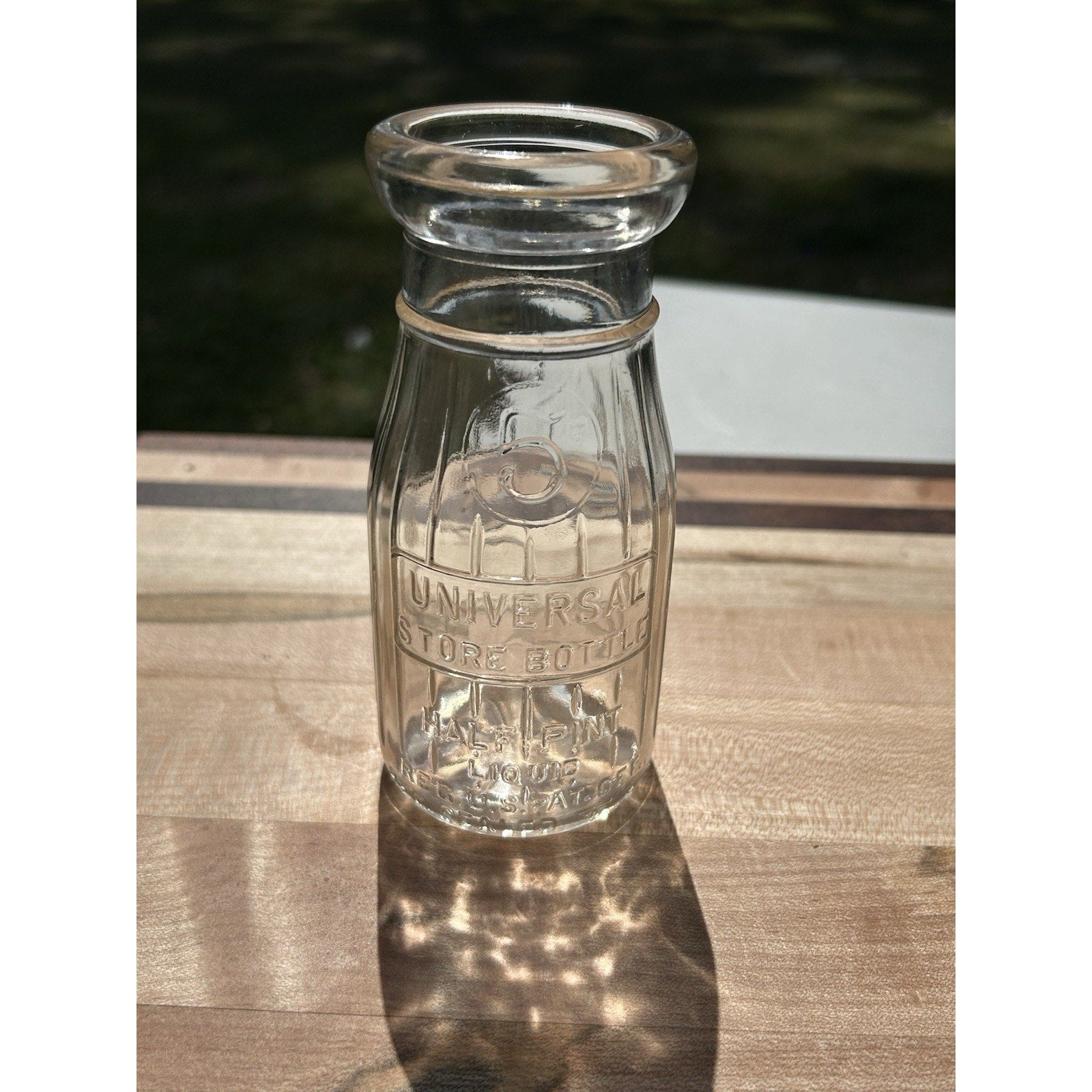 Vintage half pint dairy bottle Universal Store base embossed