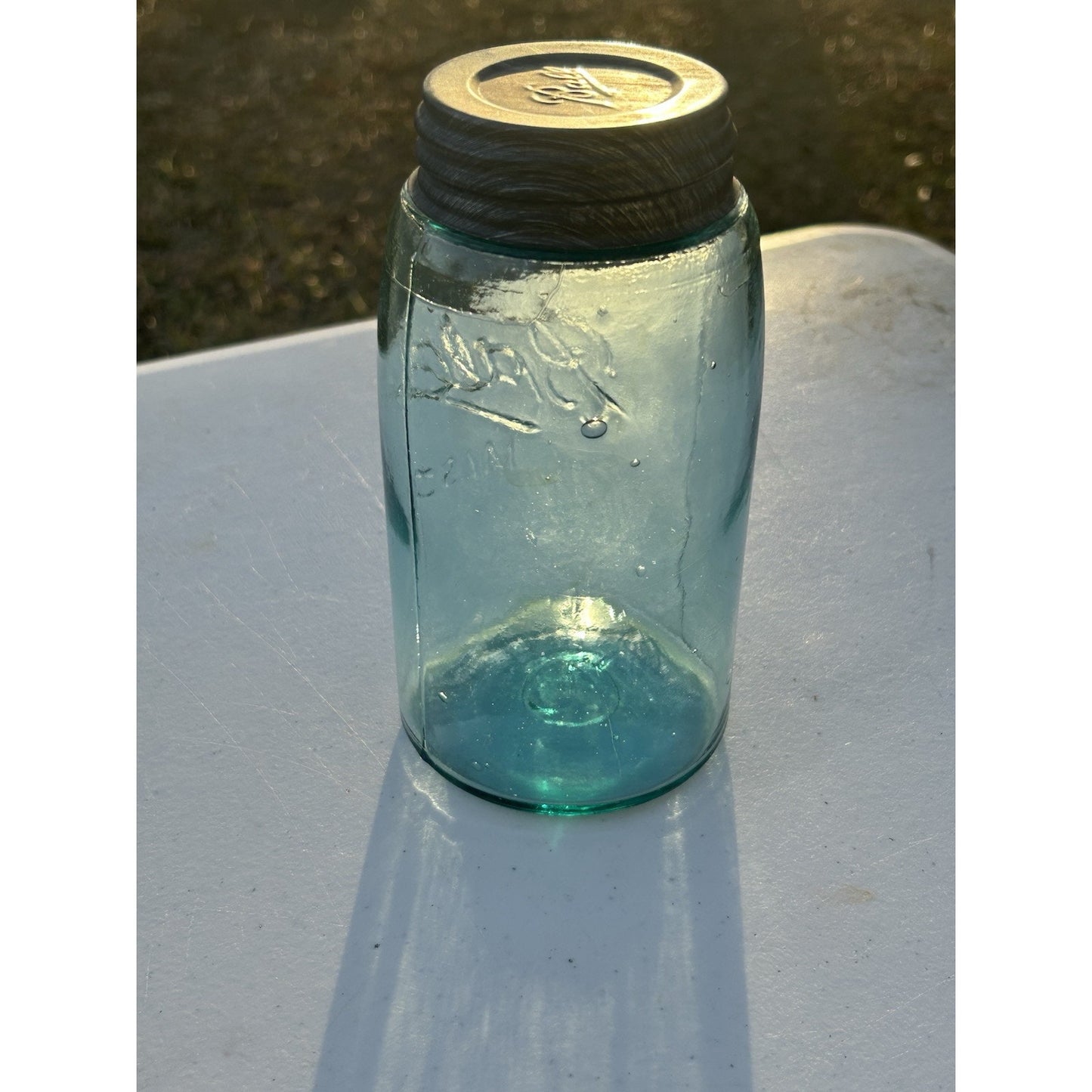 Antique Ball Triple L quart jar light through aqua glass
