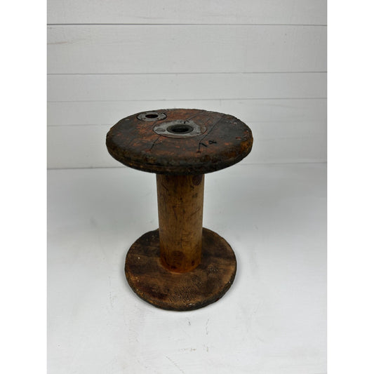 Antique Vermont textile mill bobbin — front view showing hardwood spool body with original steel end hardware and aged surface