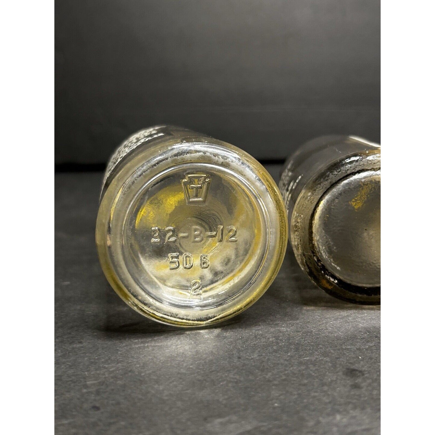 1930s Pop Kola bottles display — top view showing three matching bottles with original label coloring