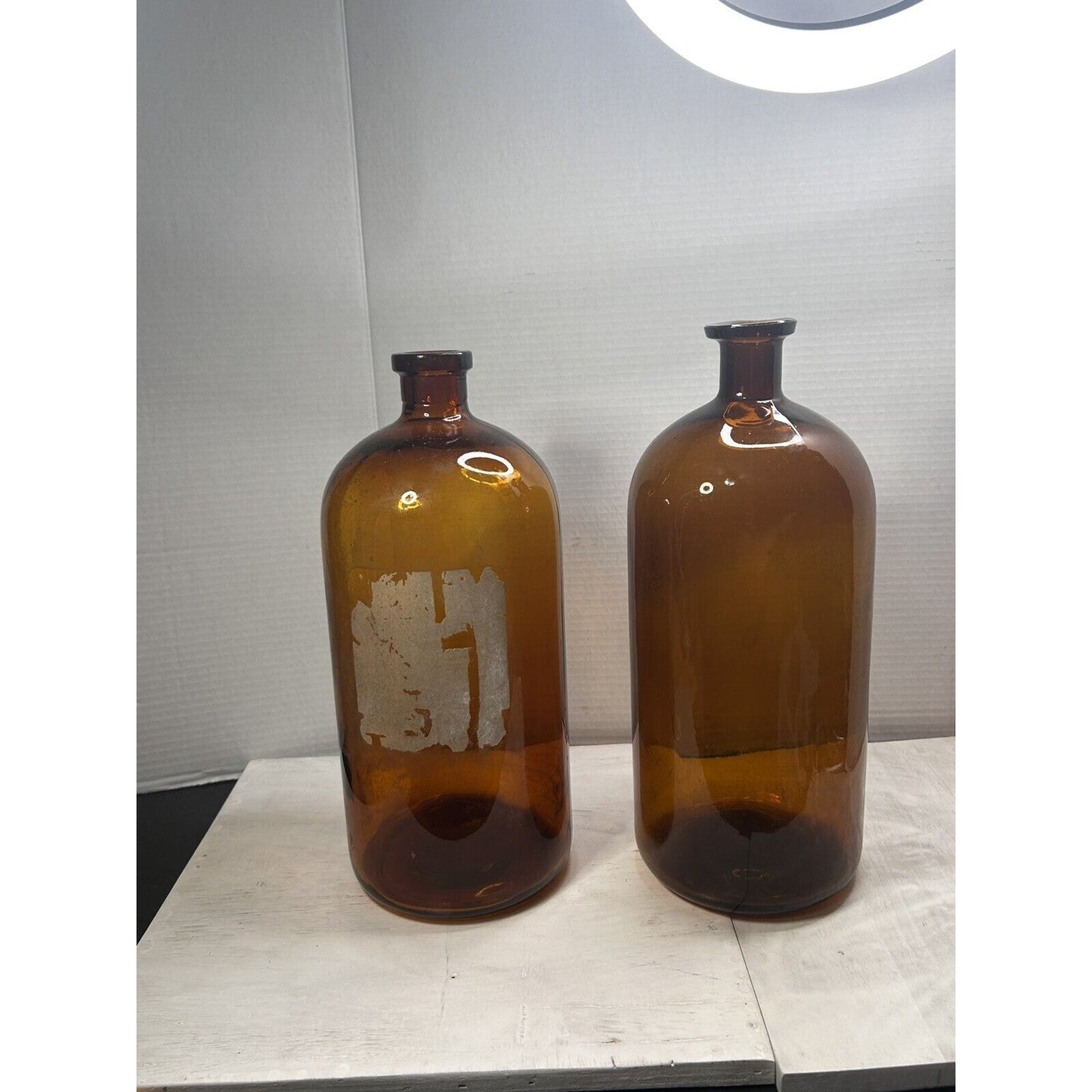 Antique large apothecary amber glass bottles pair side view