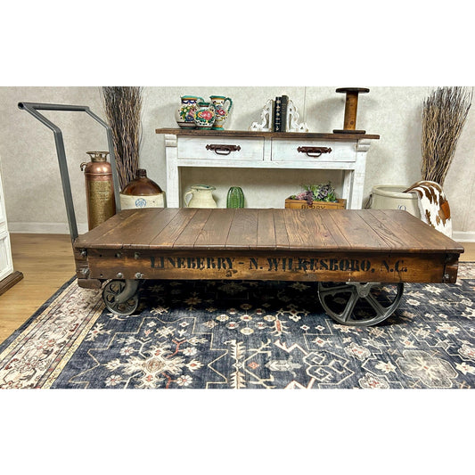 Antique Nutting factory cart restored as industrial coffee table, original cast iron wheels, hardwood deck