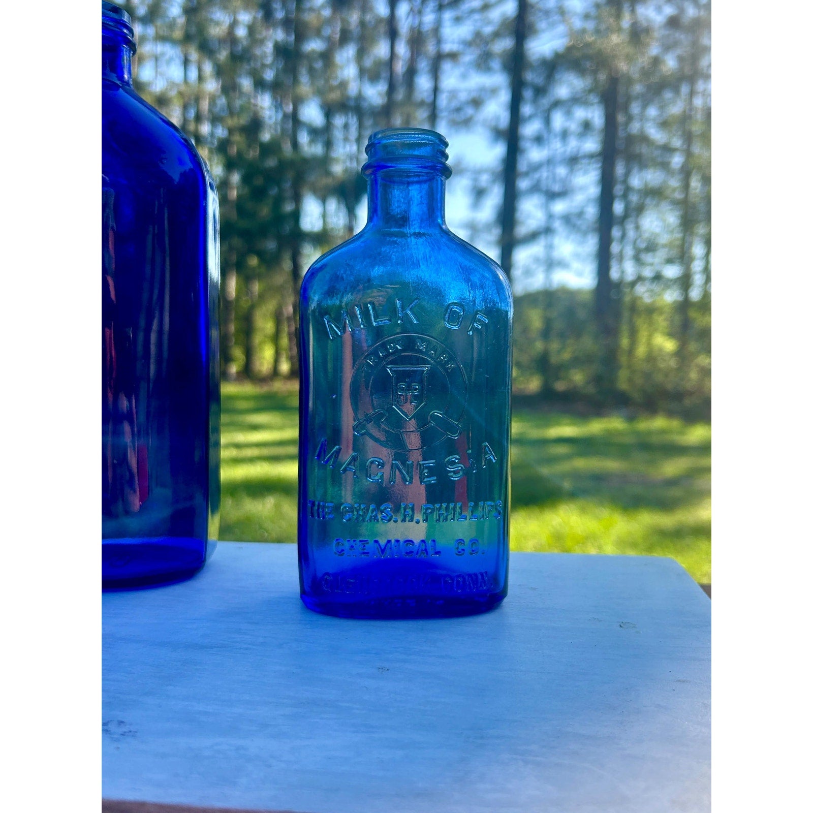 Antique cobalt blue pharmacy bottle grouping — farmhouse apothecary display three bottles
