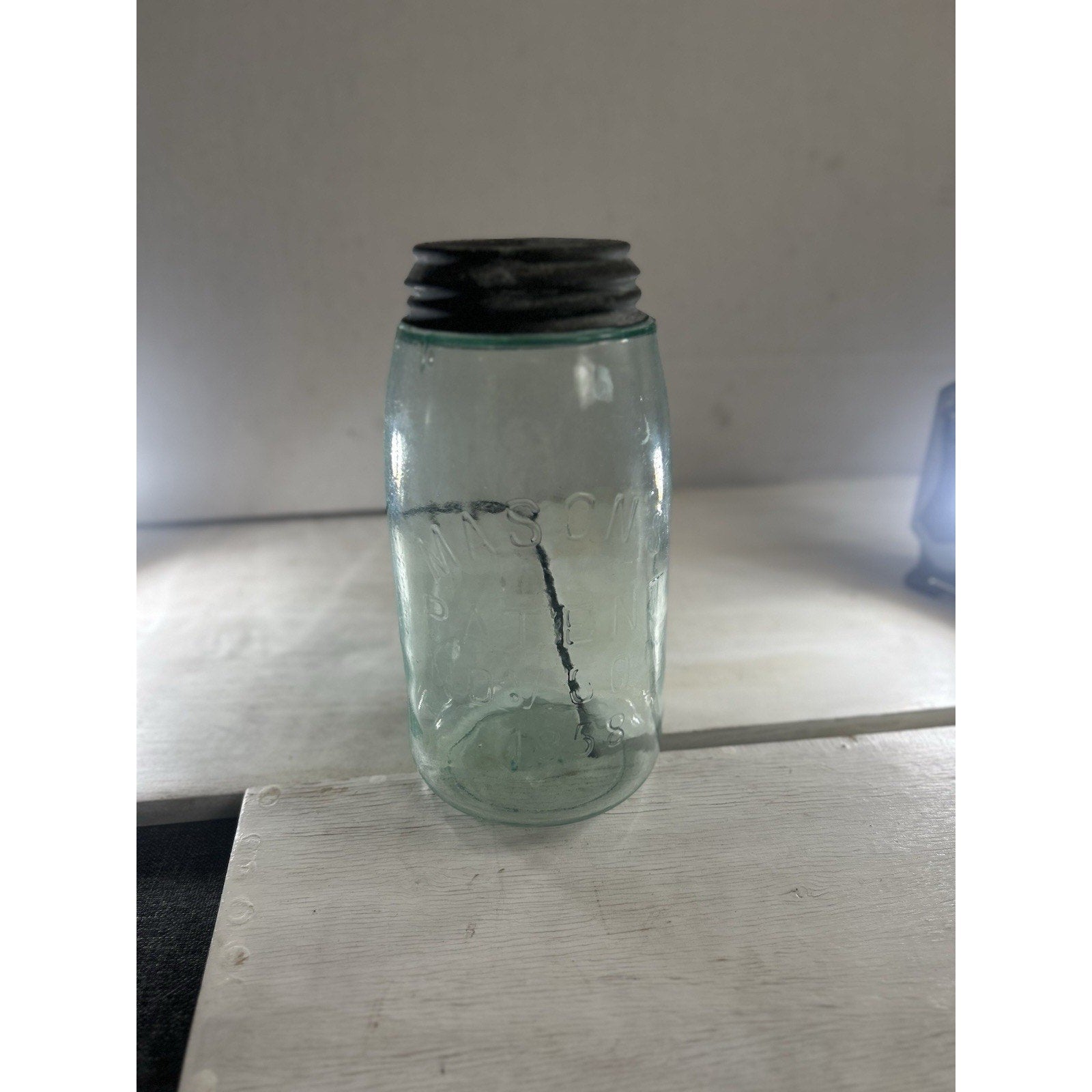 Antique Mason 1858 quart jar seed bubble detail — bubbles in aqua glass confirming early hand-production