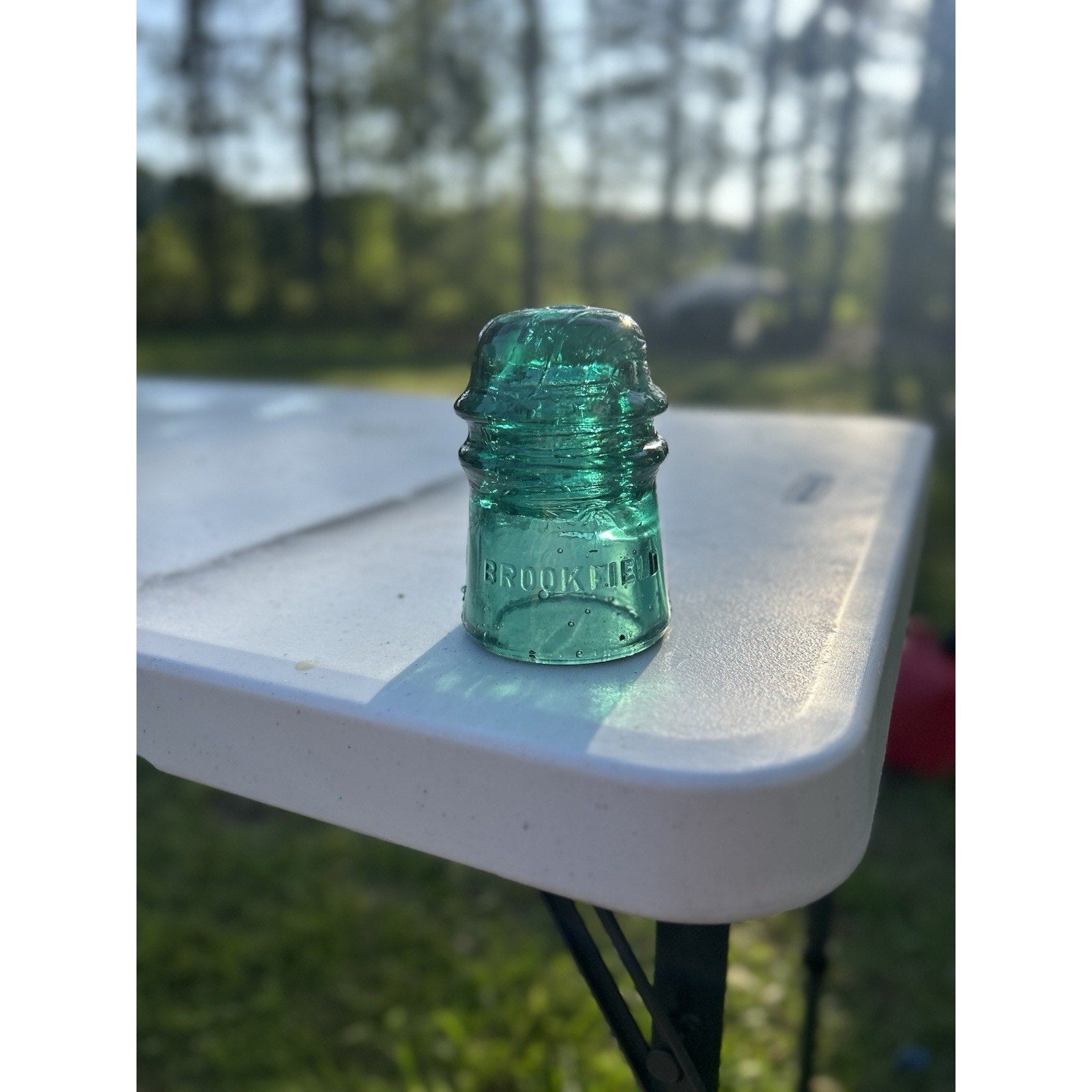 Vintage Brookfield dark emerald green insulator base marking embossed