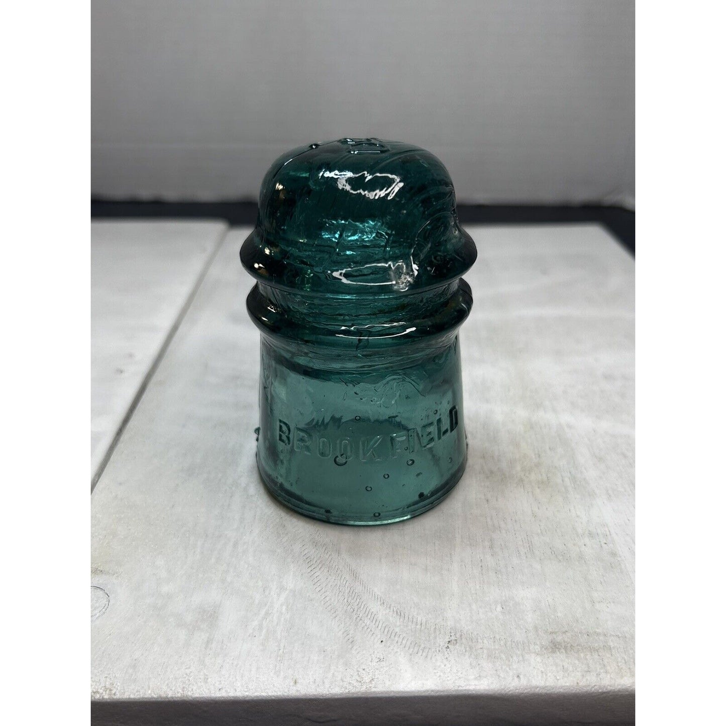 Antique GREEN BROOKFIELD Glass Insulator Embossed on the Top. Rare Gorgeous