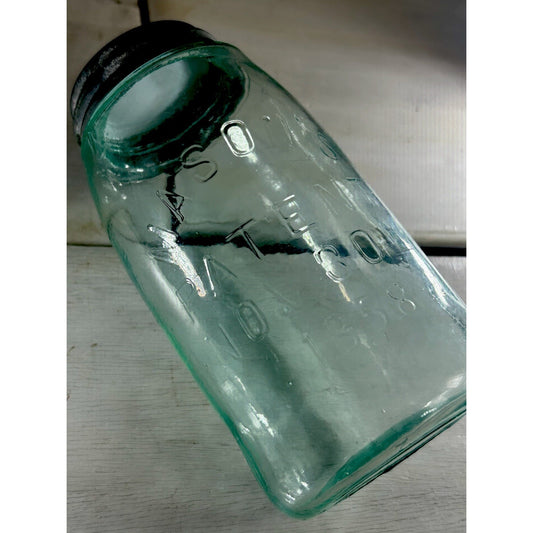 1858 Mason's Patent quart jar side profile — aqua blue glass body and original zinc lid