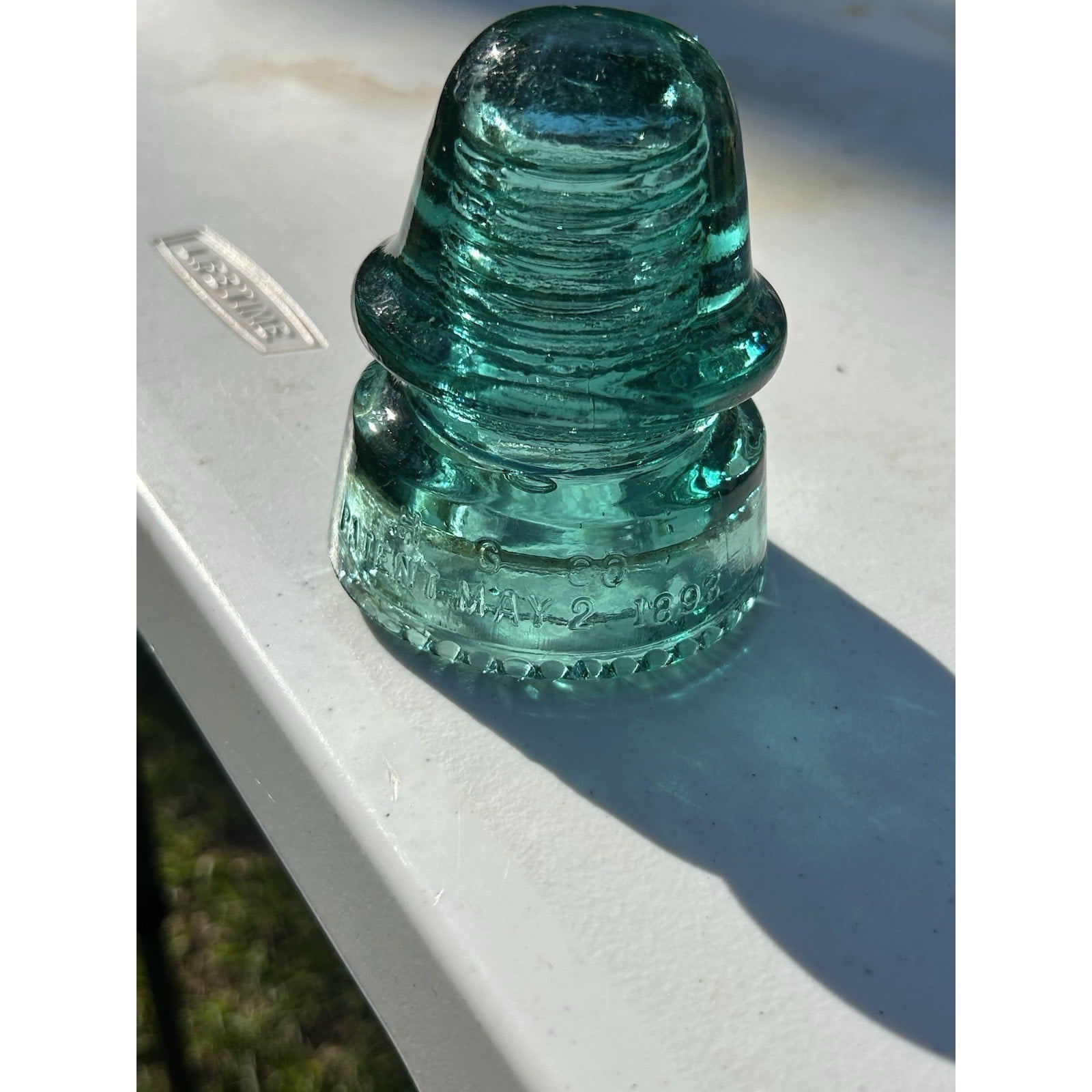 Vintage H.G. Co petticoat 1893 insulator back view green glass