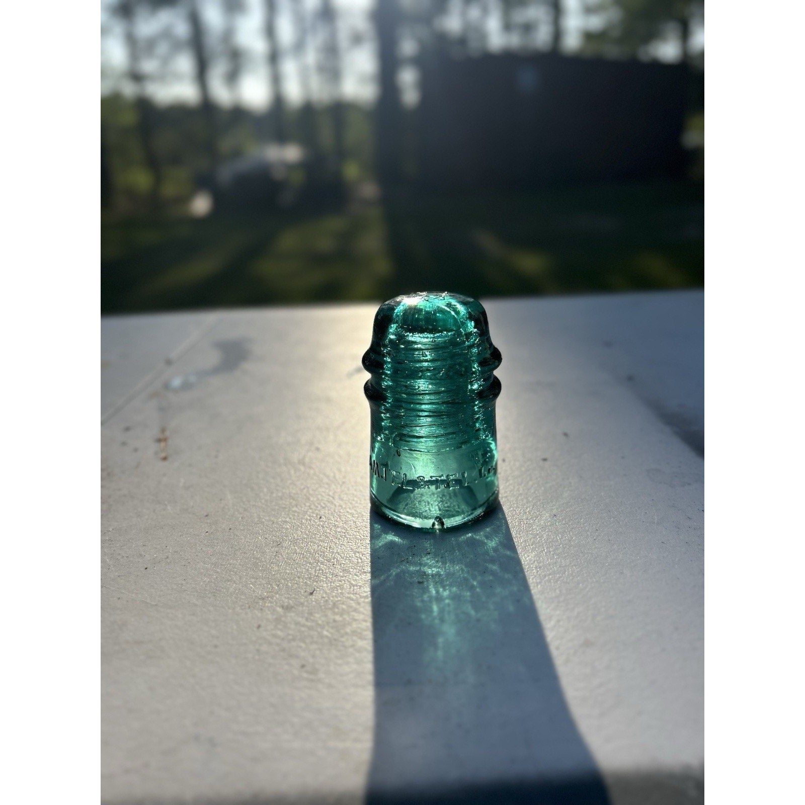 Rare vintage ice green AM TEL CO glass insulator back view