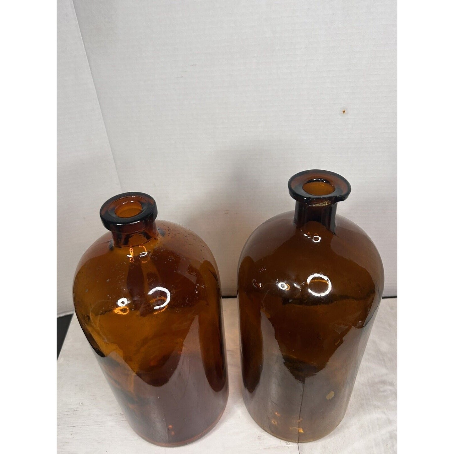 Large antique apothecary amber glass bottles natural light