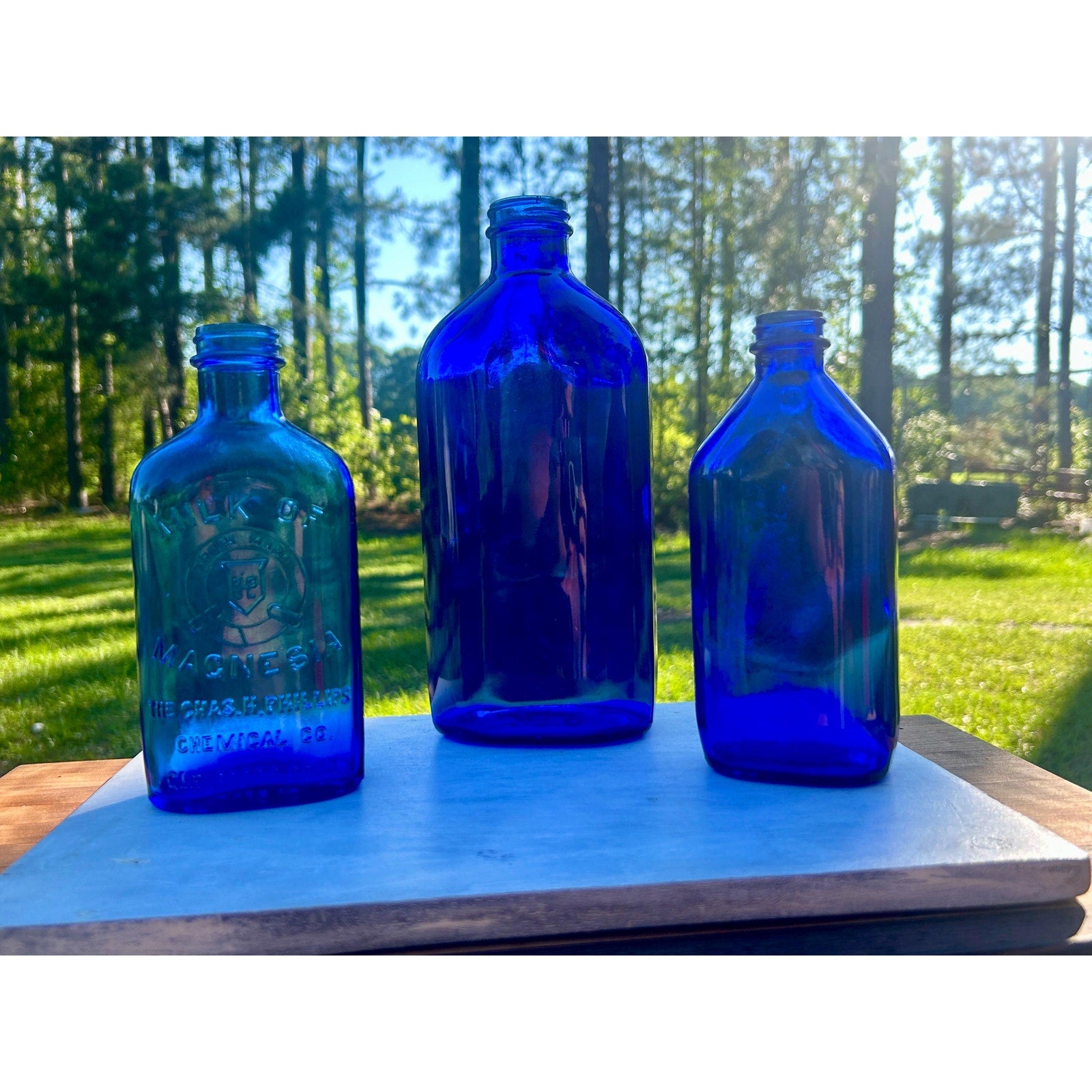 Phillips Milk of Magnesia cobalt blue bottle embossed Chas H Phillips Chemical Co Glenside Connecticut antique pharmacy glass