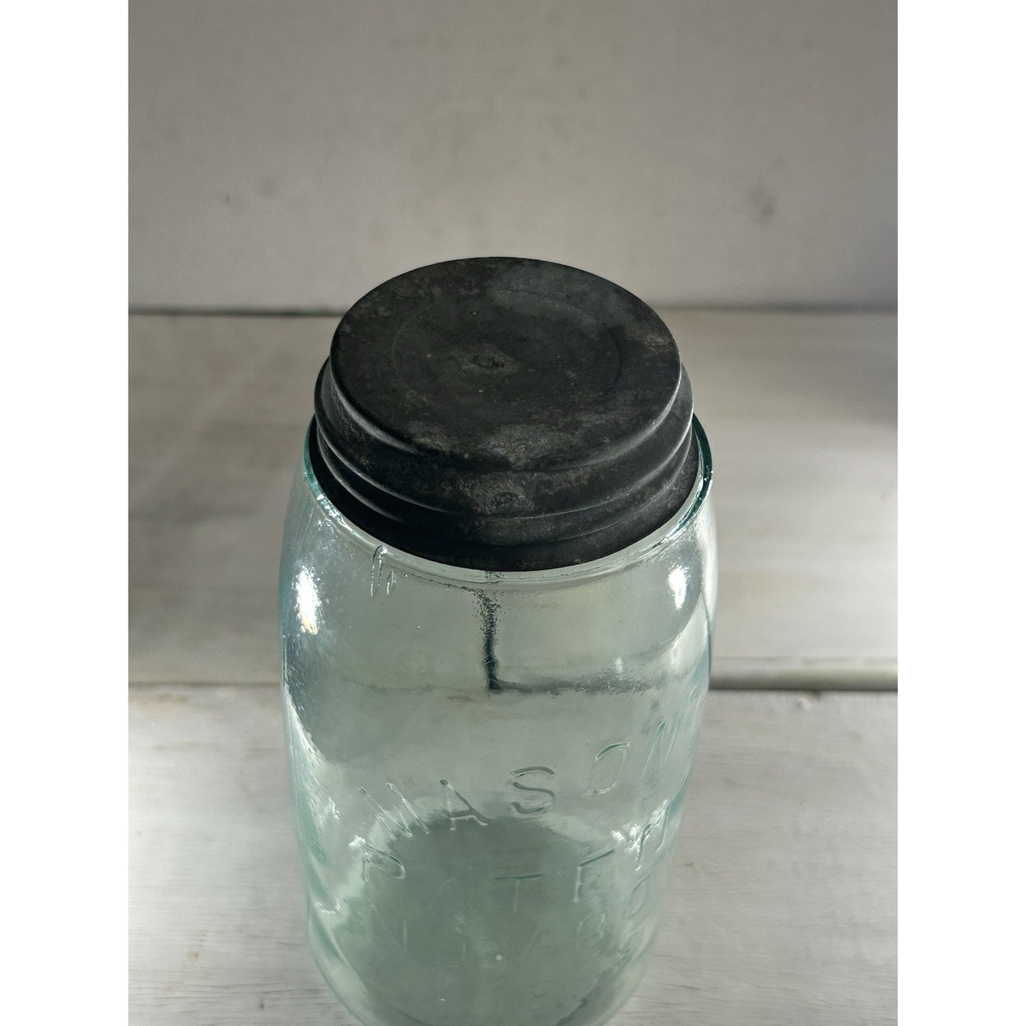 Mason's Patent Nov 30 1858 jar natural light — aqua glass tone with zinc lid, display-ready condition