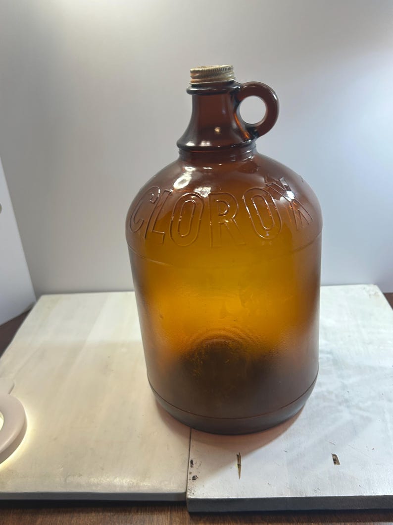 Full indoor view of the amber jug standing on a light surface.