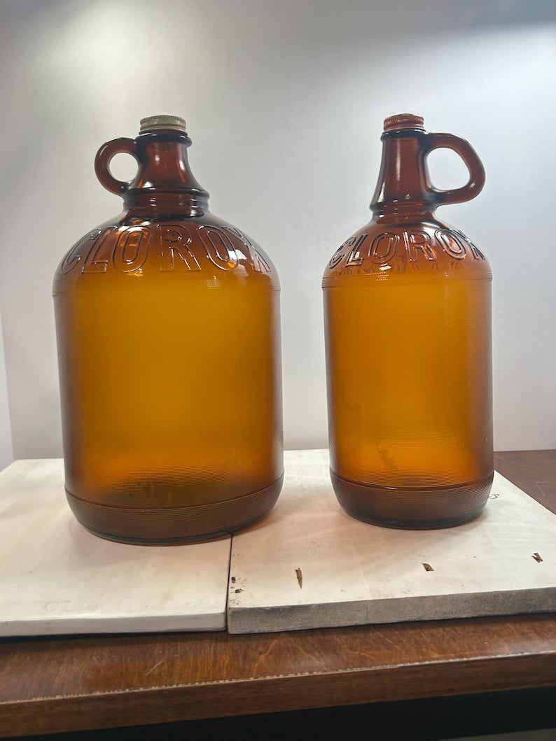 Straight front view of both amber Clorox jugs displayed together.