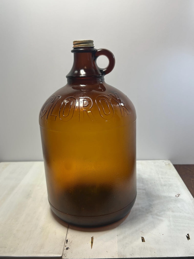 Full front view of the amber jug against a light indoor background.