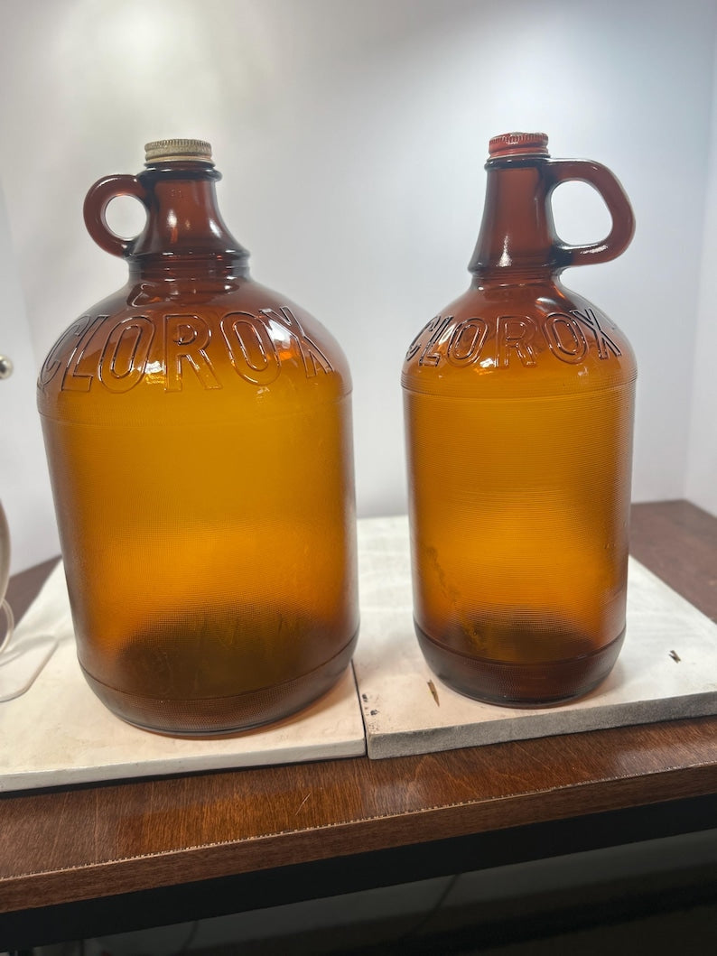 Indoor front view of the large and small amber jugs side by side.
