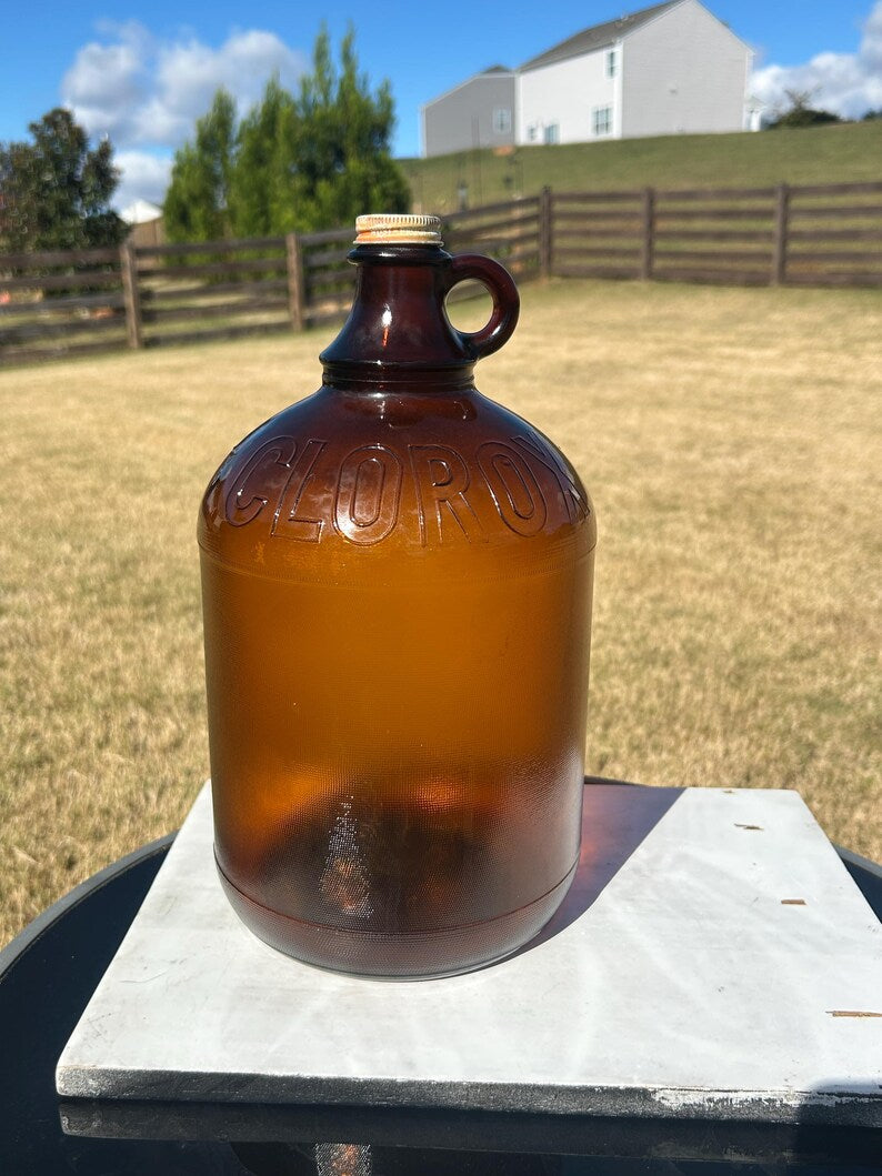 Full outdoor view of the large amber jug with loop handle.