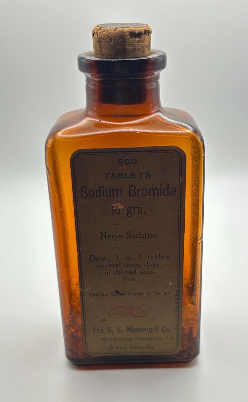 May include: An antique amber glass bottle with a cork stopper. The label reads "500 Tablets Sodium Bromide" and "Nerve Sedative". The bottle is from The S. E. Massengill Co., Bristol, Tenn.-Va.