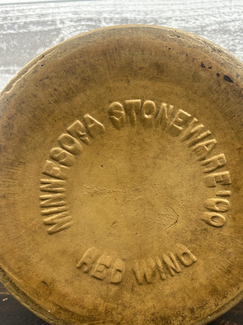Close-up of the impressed Minnesota Stoneware Company bottom lettering.
