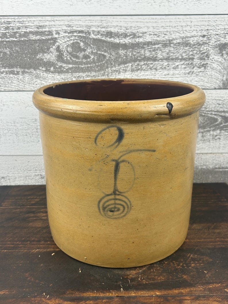 Full front view of the cylindrical crock with cobalt number and target motif.
