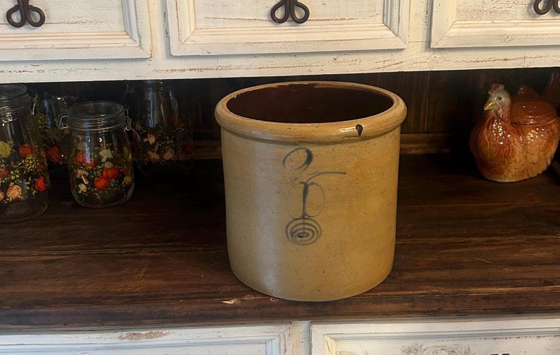 Two-gallon crock displayed on a kitchen floor for room-scale context.