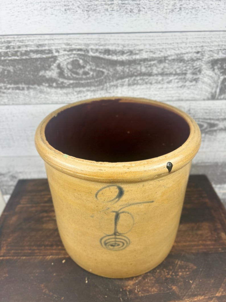 High angled view into the crock showing the dark brown glazed interior.