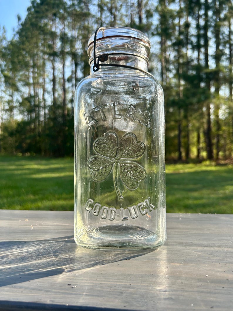 Angled outdoor view of the square jar with wire-bail closure.
