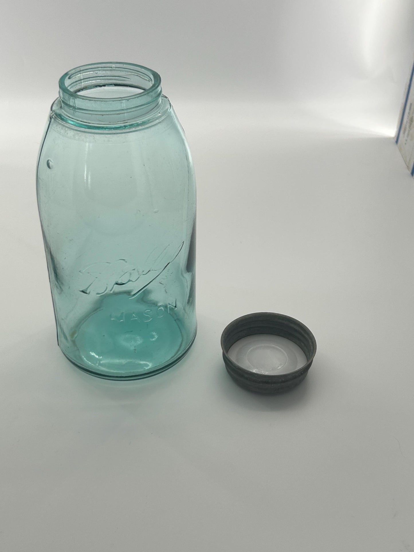 Aqua blue glass and seed bubbles in Ball jar